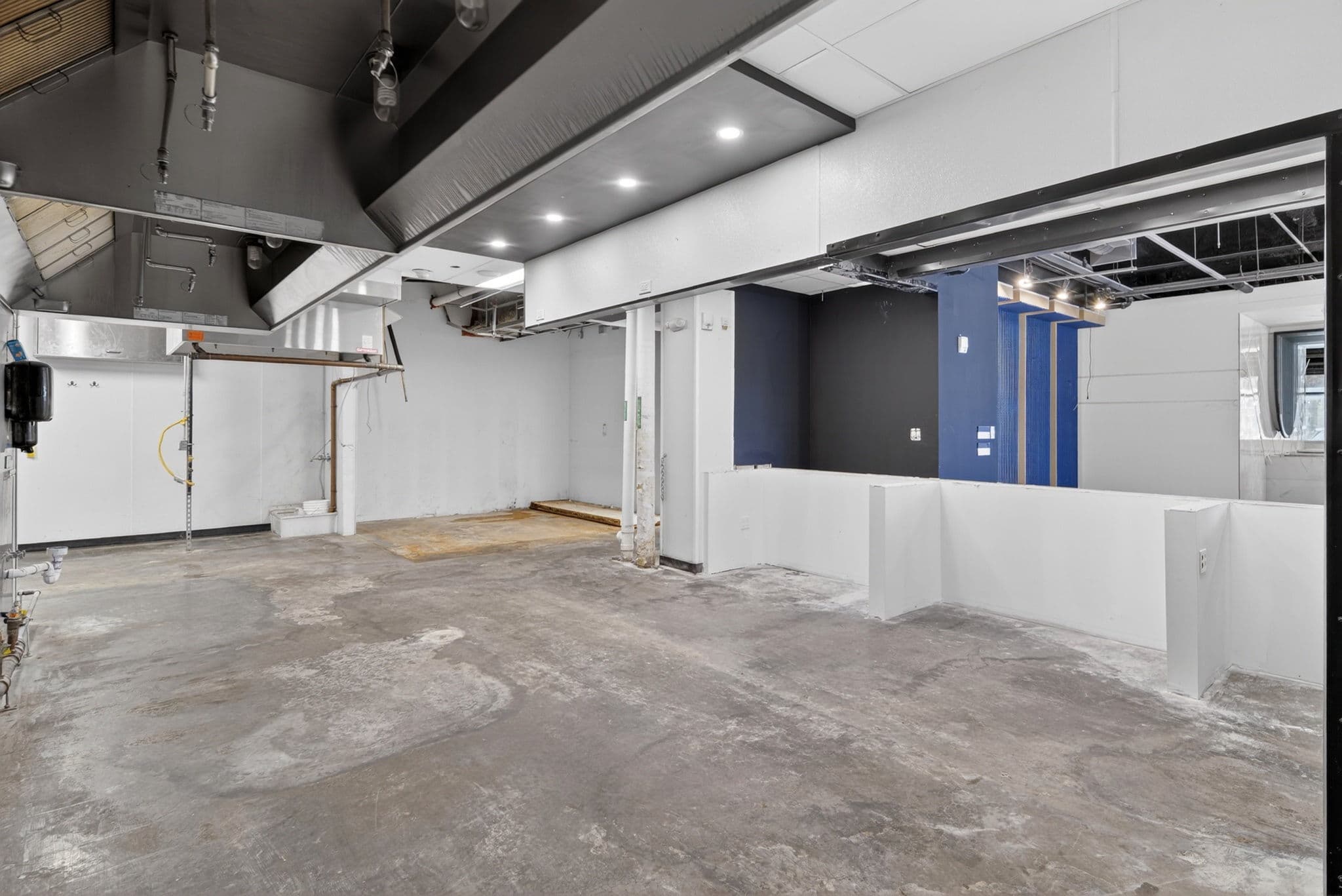Below-grade lounge volume — ideal for simulators & VIP (as-is)